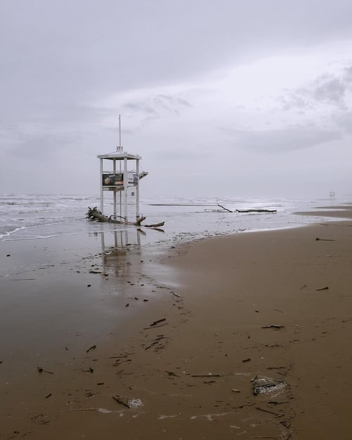 A composite image showing the effects of climate change, including rising sea levels, extreme weather events, and droughts. The image also includes scenes of overcrowded refugee camps and conflicts over scarce resources.