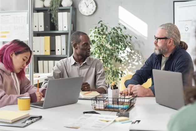 A diverse group of entrepreneurs working together in a co-working space, with laptops and documents spread across the table, illustrating collaboration and the use of resources and technology to develop their business plans.