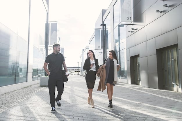 People walking into a modern office building during the day, symbolizing job opportunities and a thriving workforce.