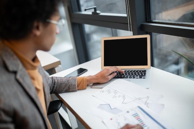 A person using a computer to research disability benefits, with charts and legal documents on the screen, indicating personal research and planning.